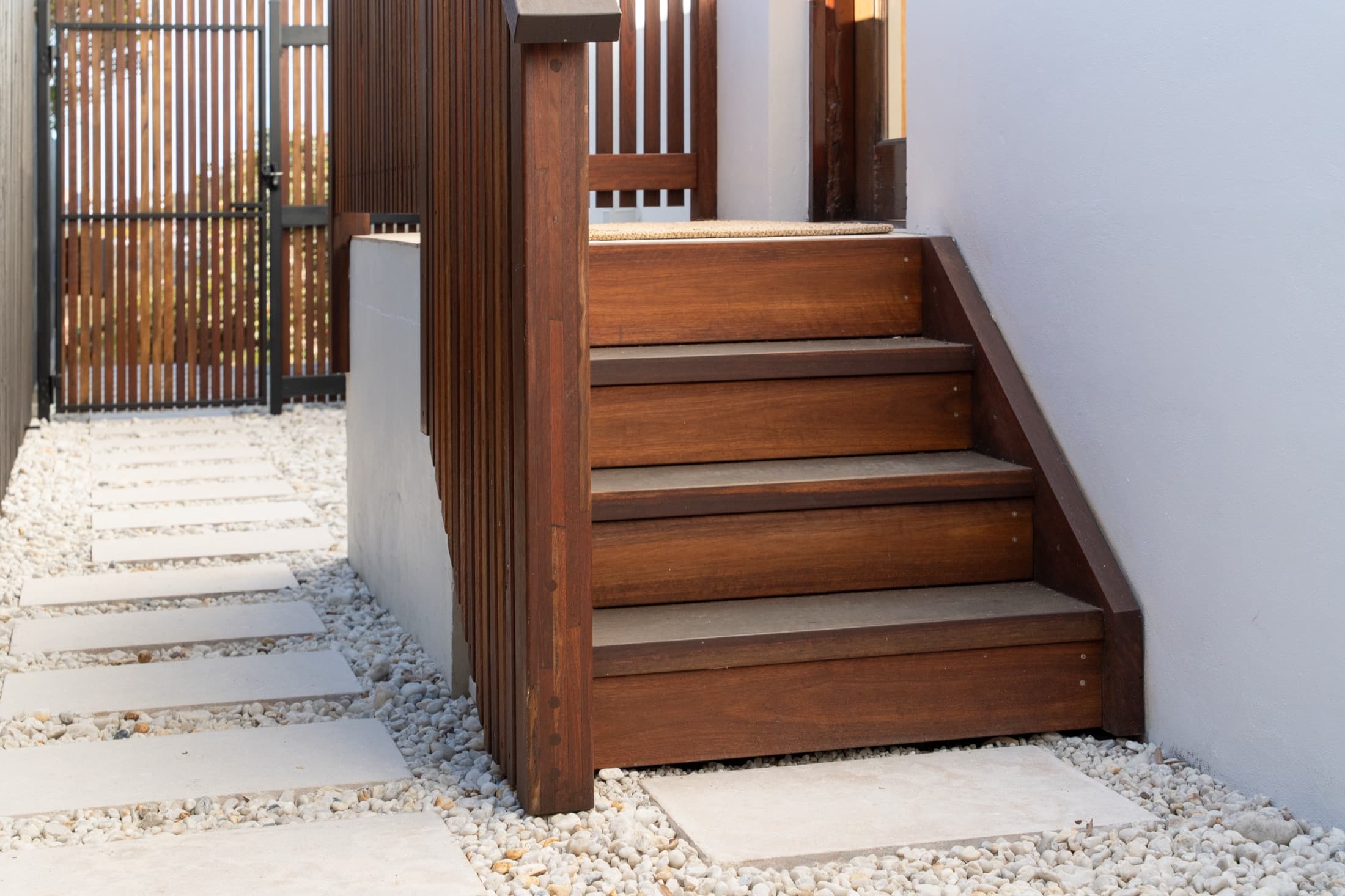The same view after: hardwood steps and sandstone pads set in white pebble